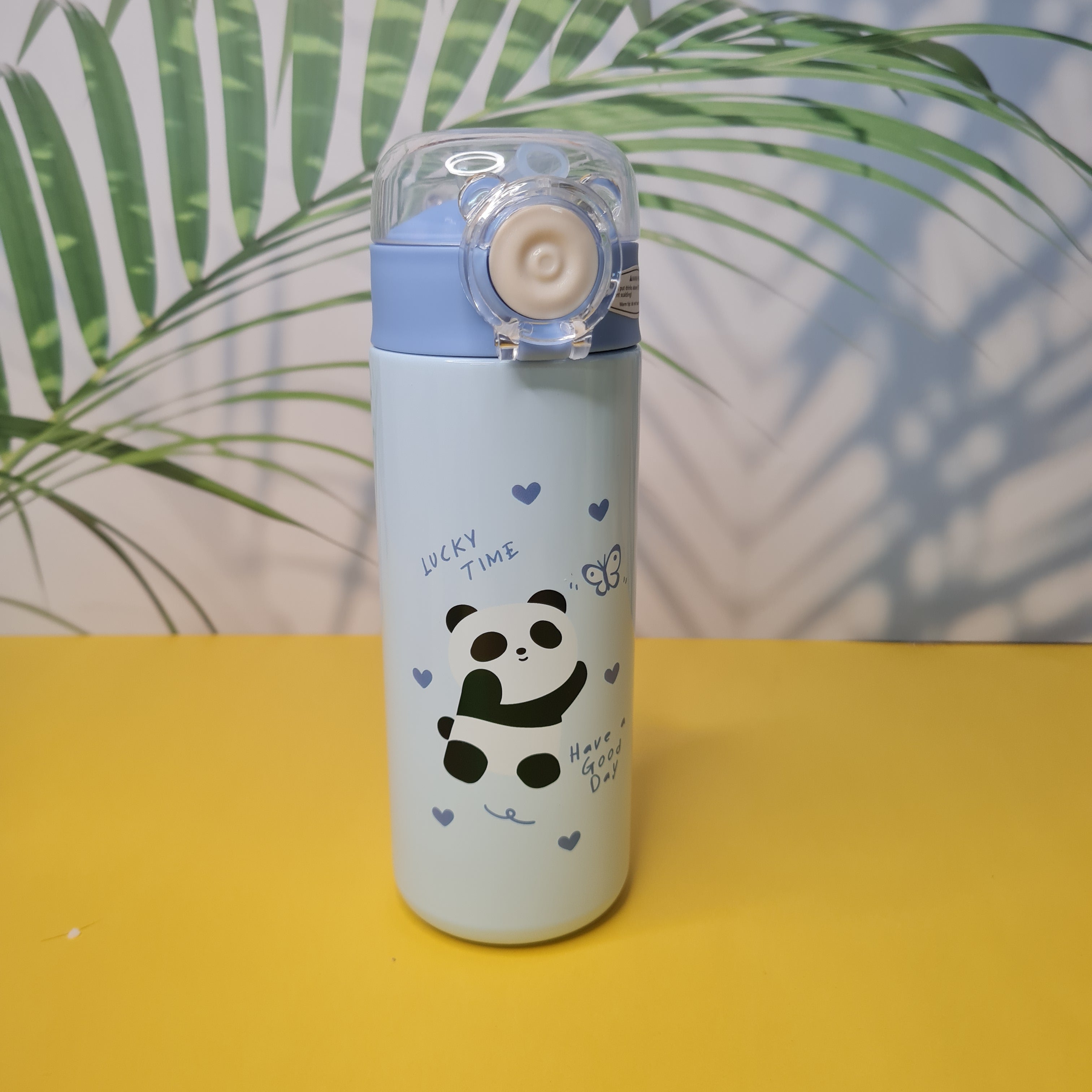 Panda-themed bottle with a yellow background and green leaves